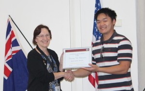President Dennis Foo accepts 3rd place for the best Newsletter in the District from PRM Almarie Meyer